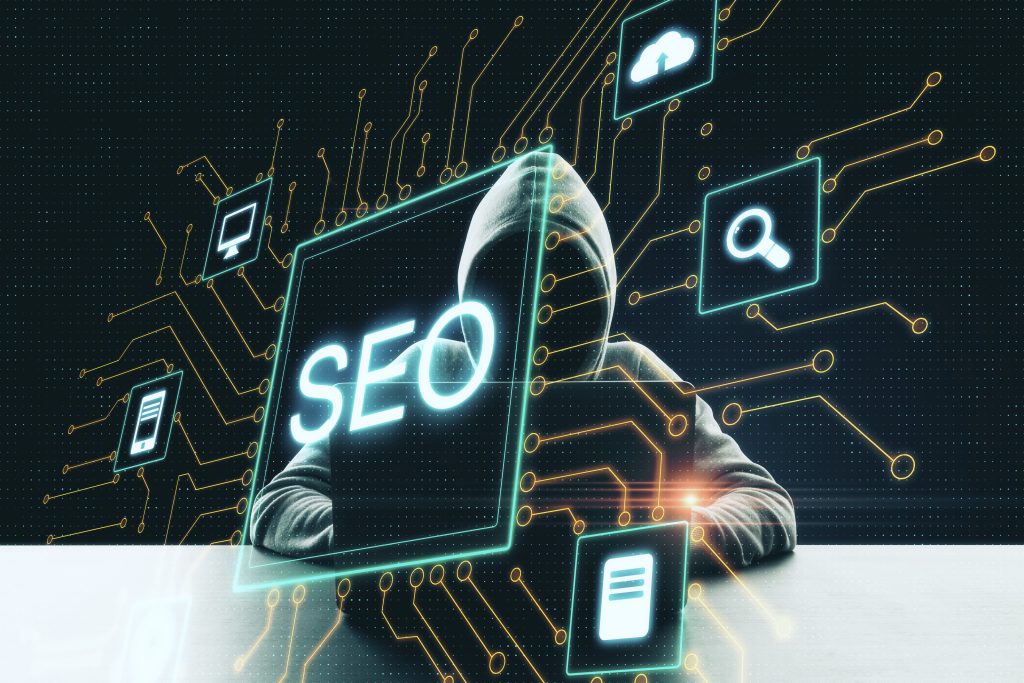 Hacker with a laptop and an abstract SEO hologram